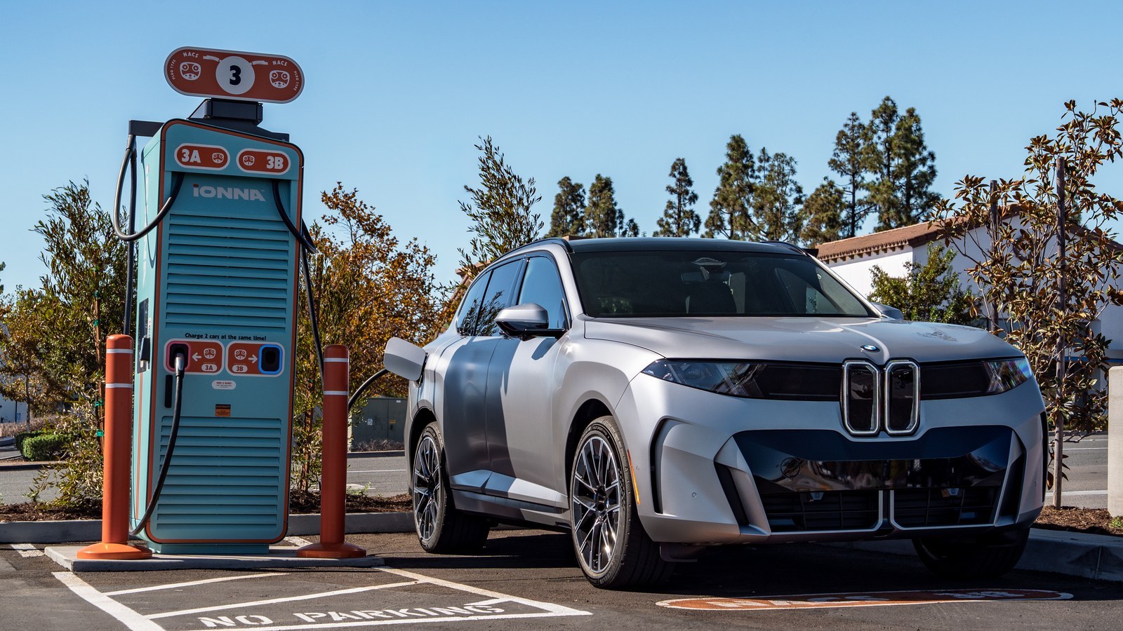 Silver BMW iX5 60 xDrive plugged into an IONNA charger