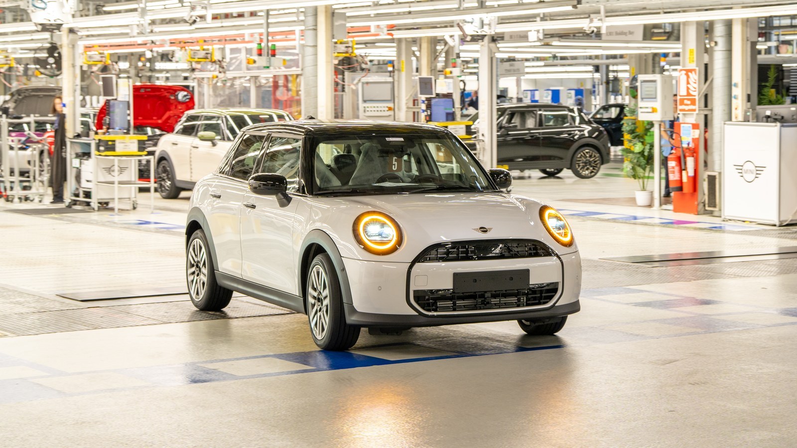 White MINI Cooper 5-door driving through the Oxford plant