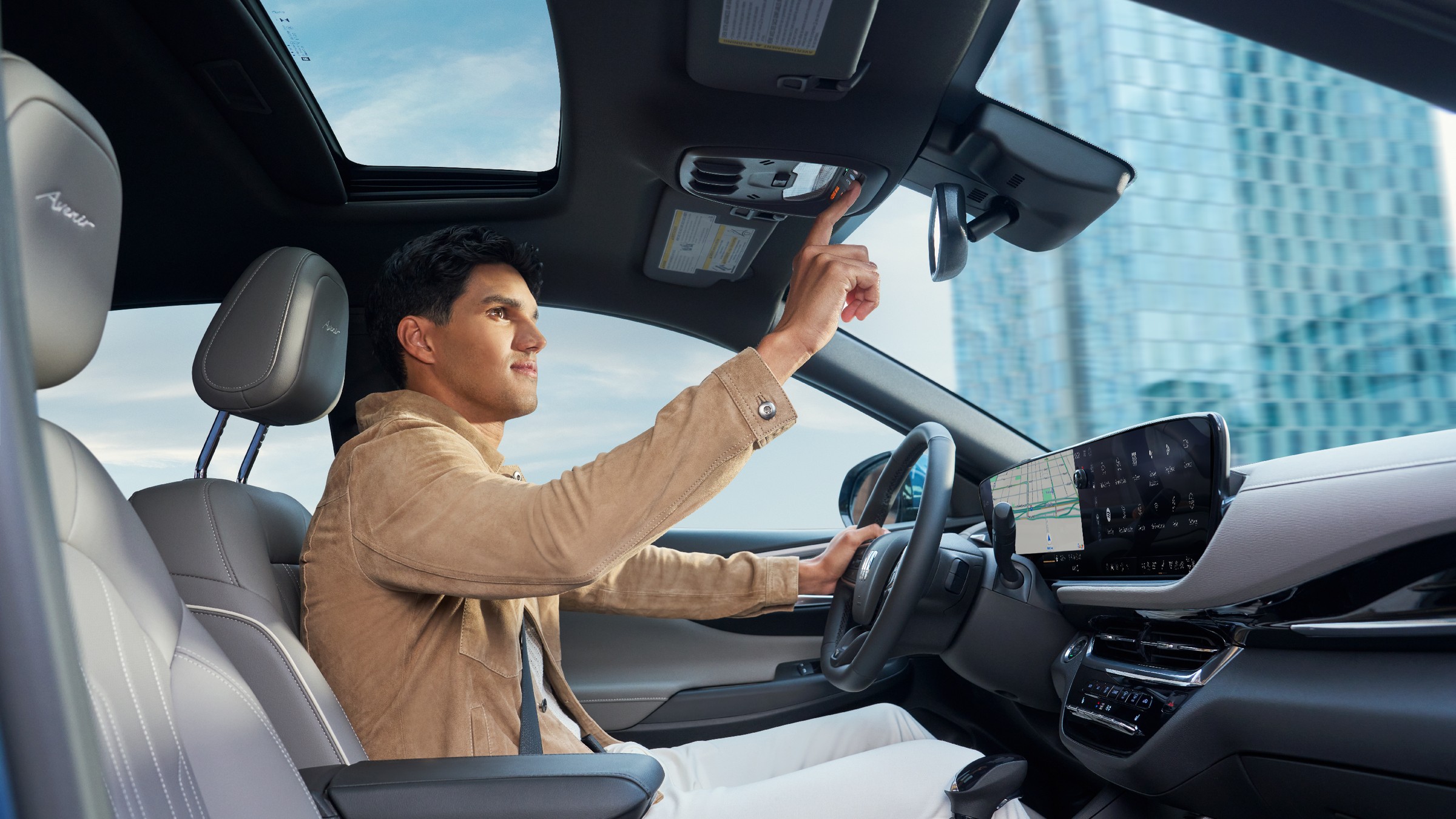 Driver pressing the OnStar button on a Buick Envista overhead console