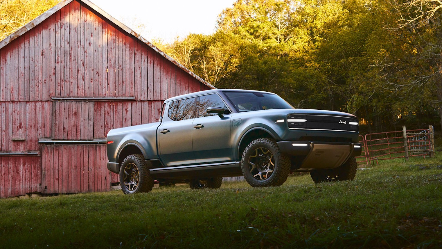 Scout Terra pickup parked beside a red barn