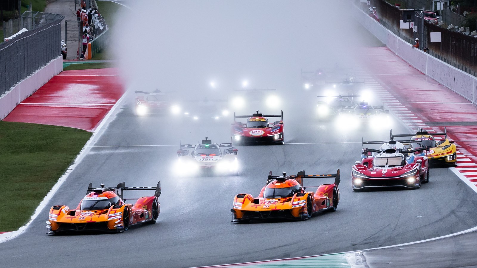 Two orange Genesis GMR-001 Hypercars lead the wet start at Barcelona