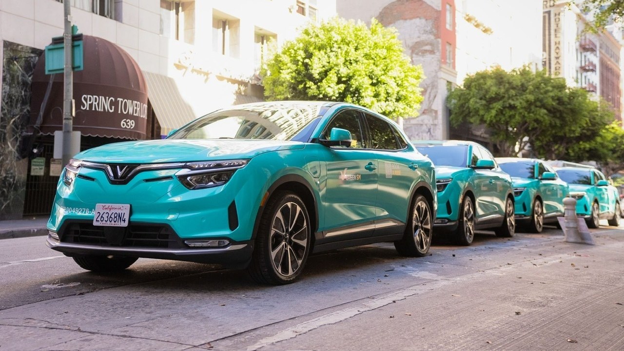 Green SM VinFast VF 8 taxis lined up in Los Angeles