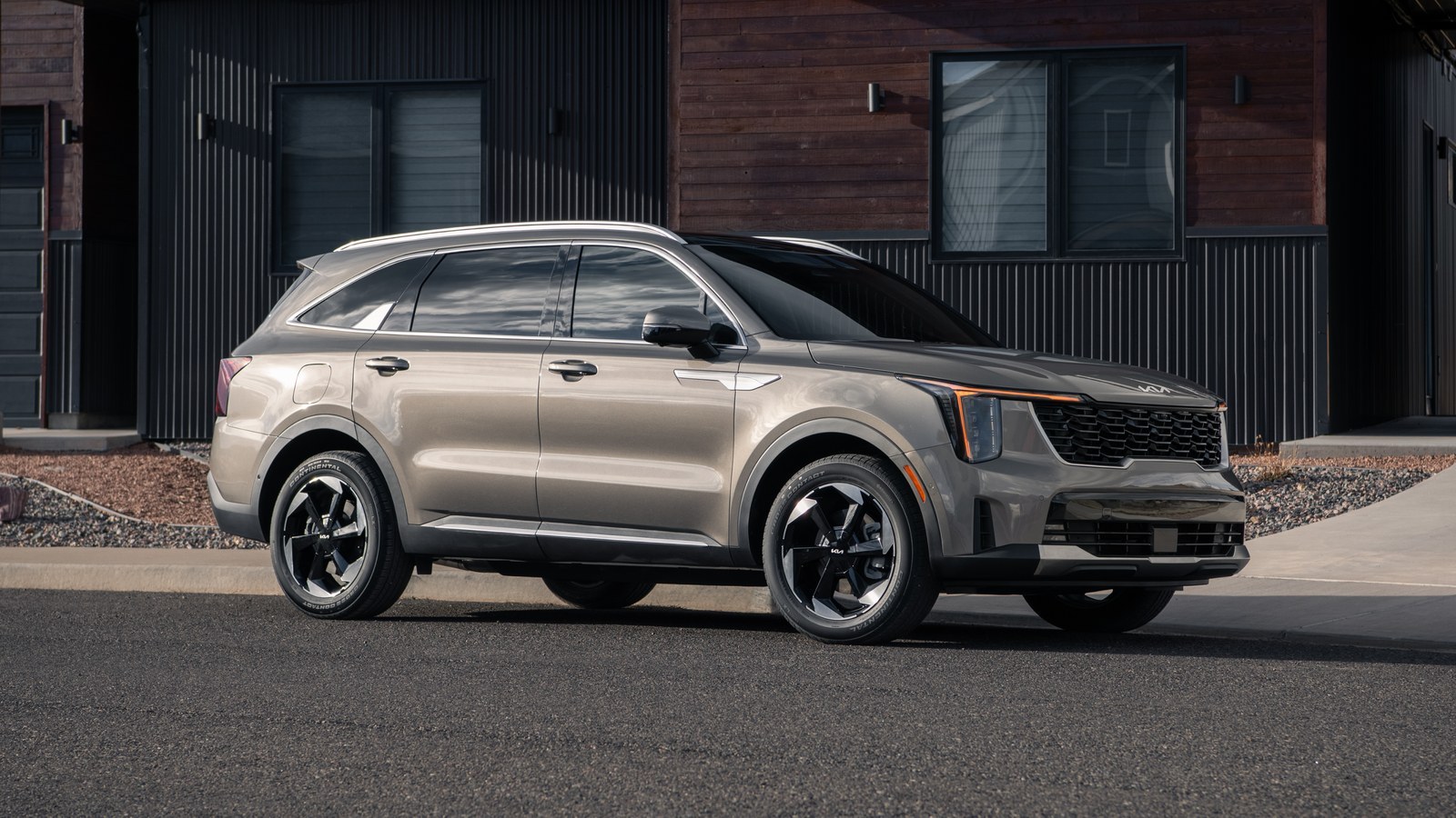 2027 Kia Sorento Plug-in Hybrid parked in front of a wooden house