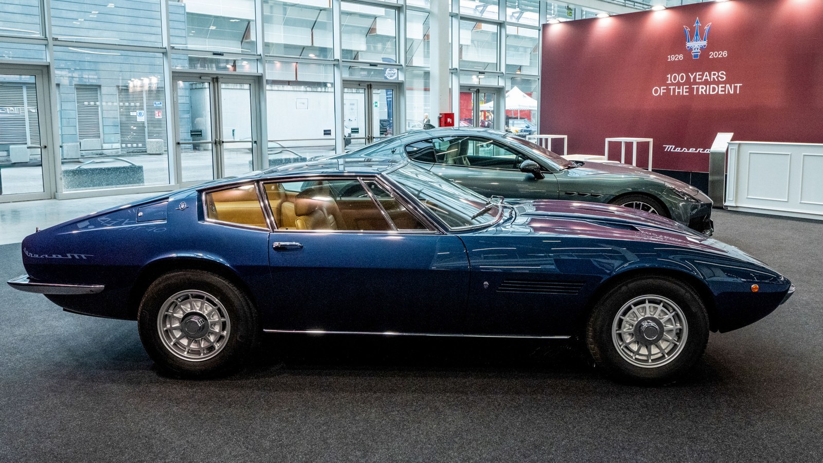 Blue 1972 Maserati Ghibli SS beside a green GranTurismo Trofeo