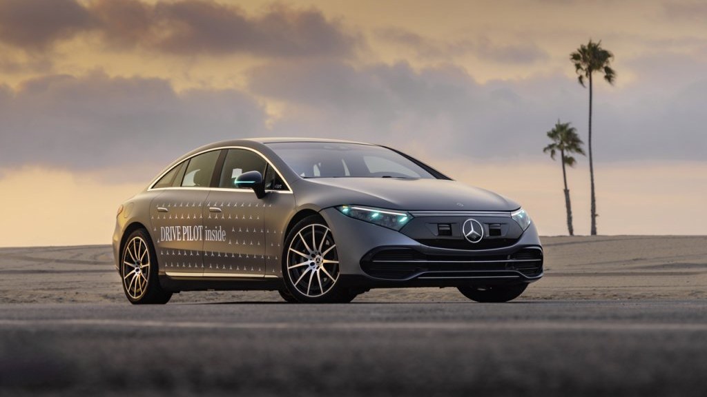 Mercedes-Benz EQS DRIVE PILOT test car with cyan marker lights at sunset