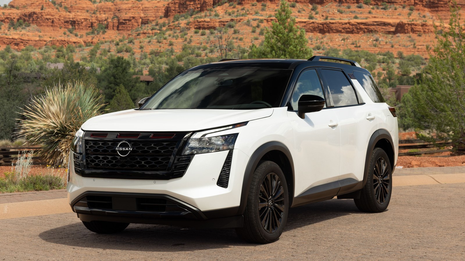2027 Nissan Pathfinder Special Edition front three-quarter view, red rocks behind