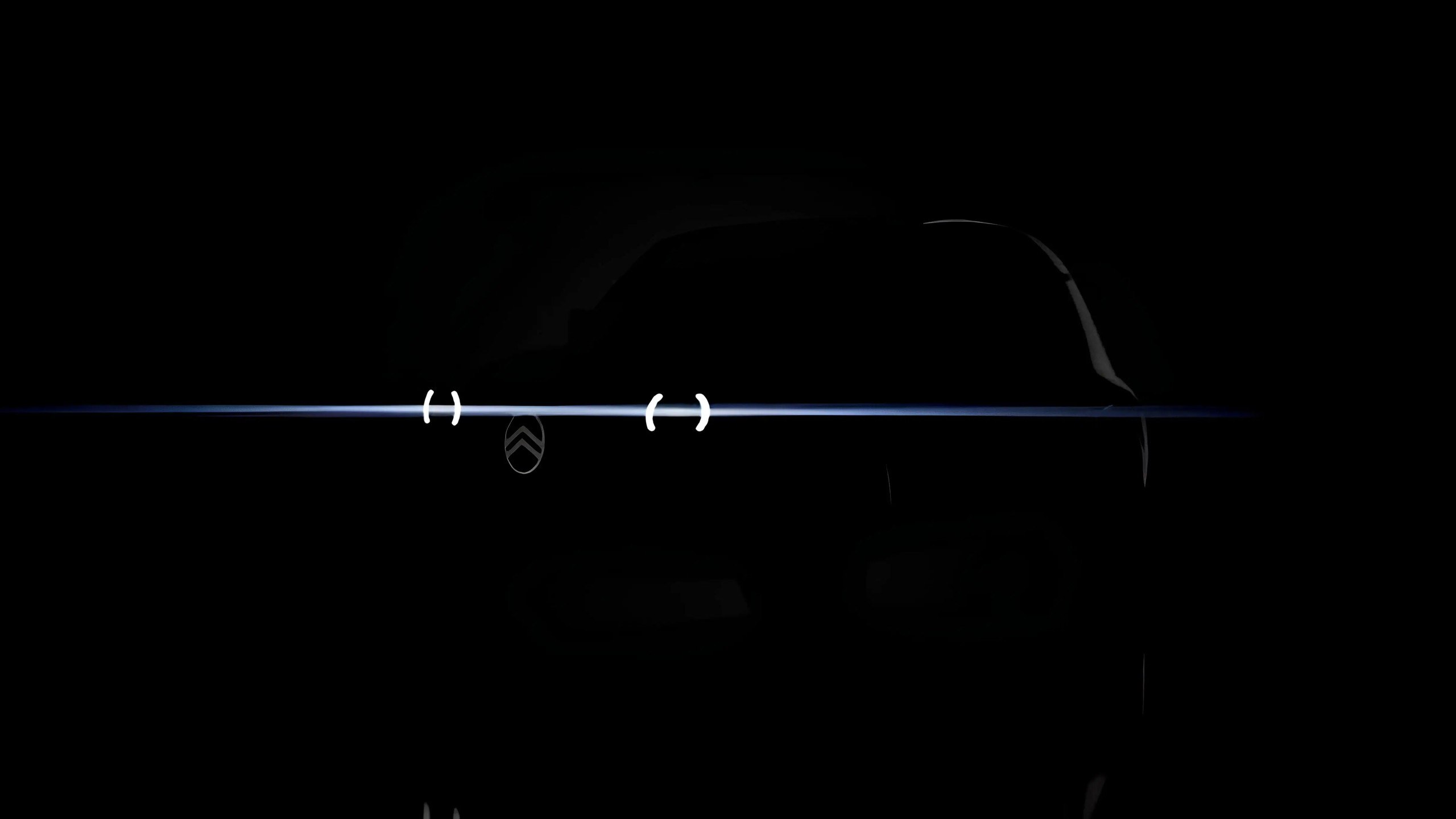 Teaser of Citroën's electric 2CV concept with its headlights lit