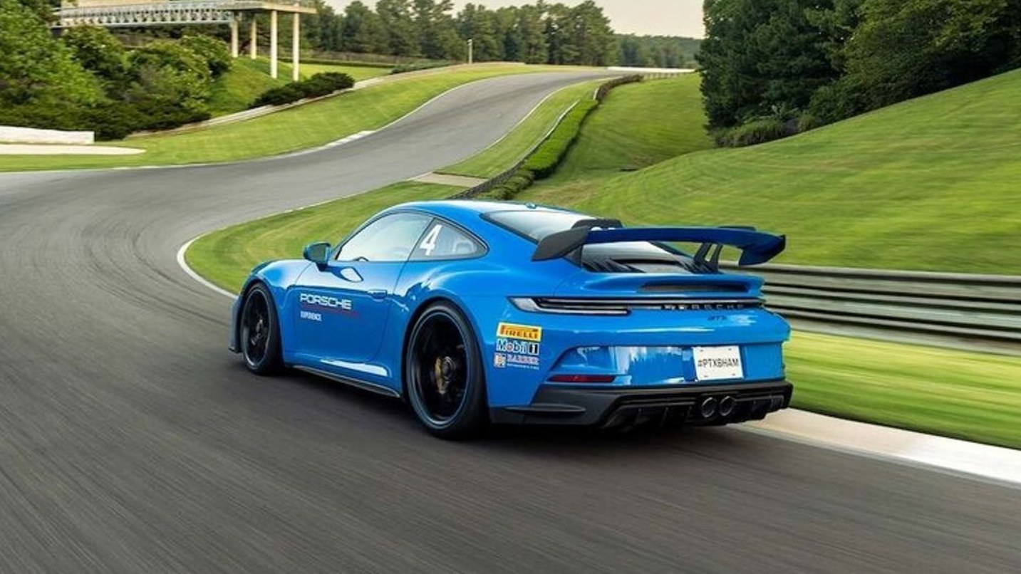 Blue Porsche 911 GT3 cornering at Barber Motorsports Park