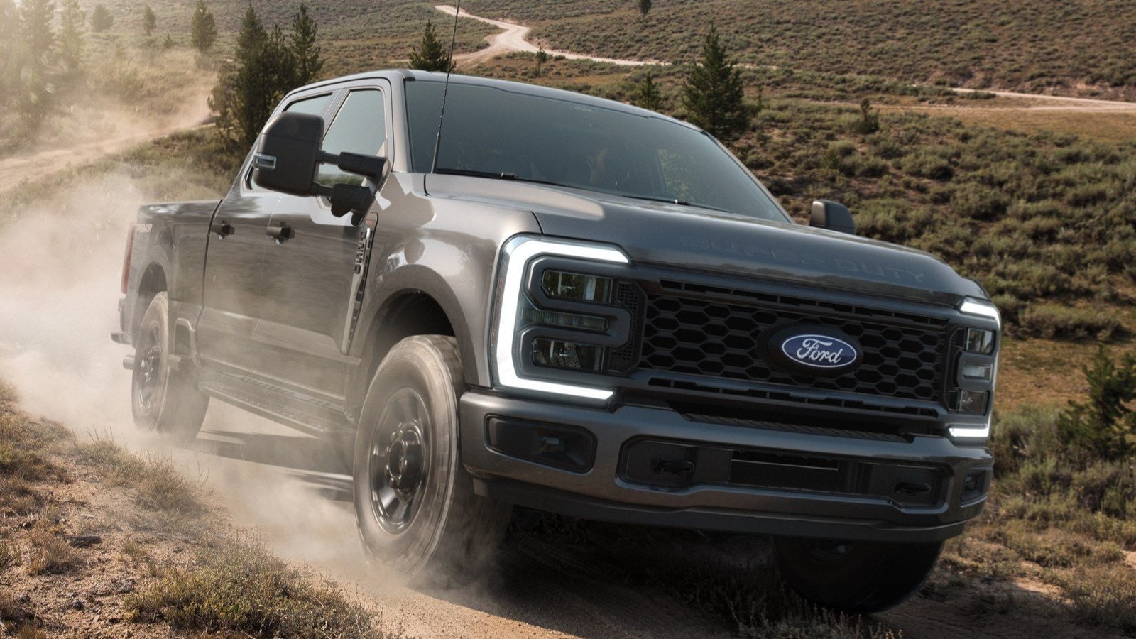 Gray Ford Super Duty F-250 Tremor driving on a dusty trail