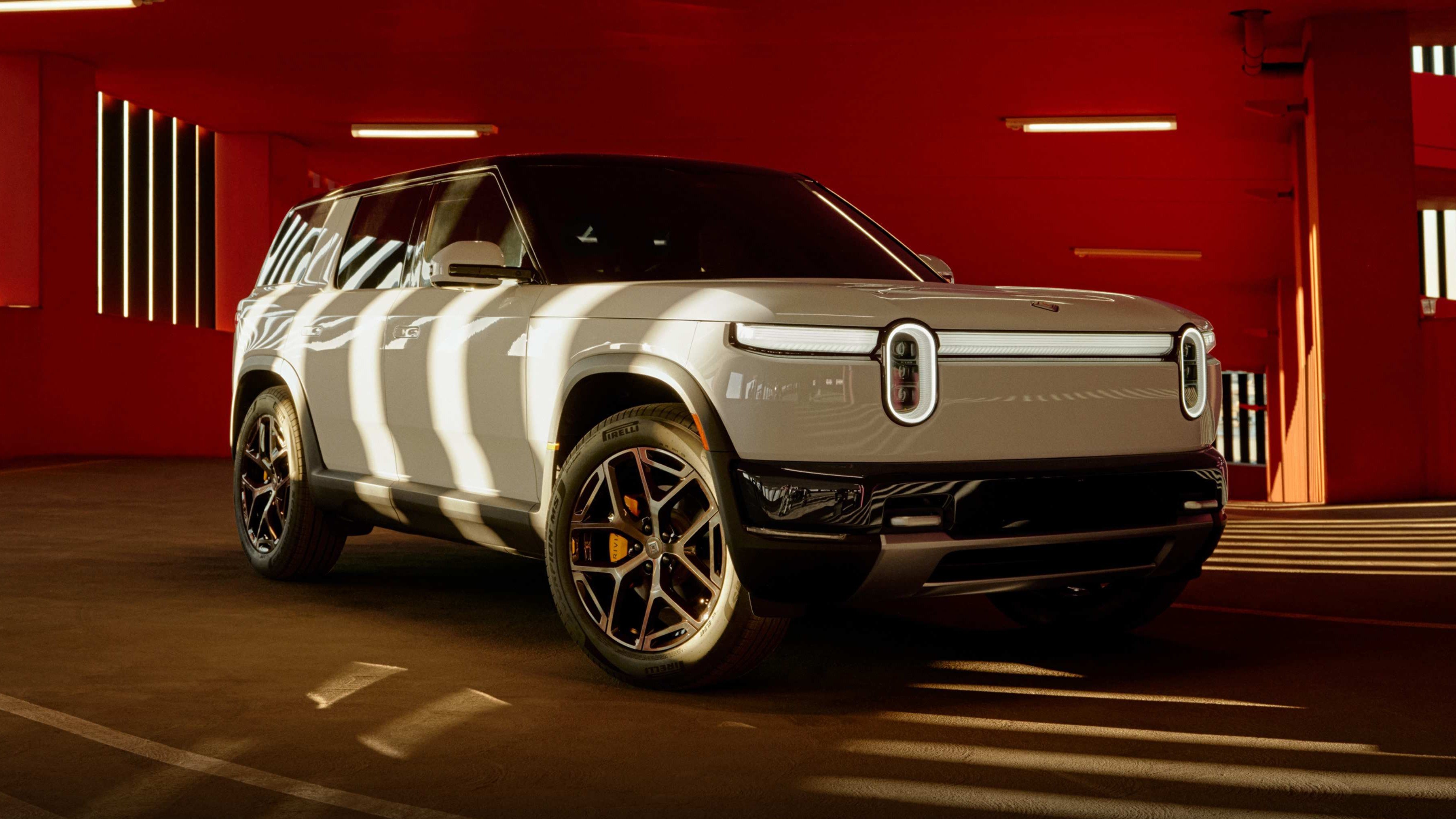 Silver Rivian R2 electric SUV, front three-quarter view in a parking garage