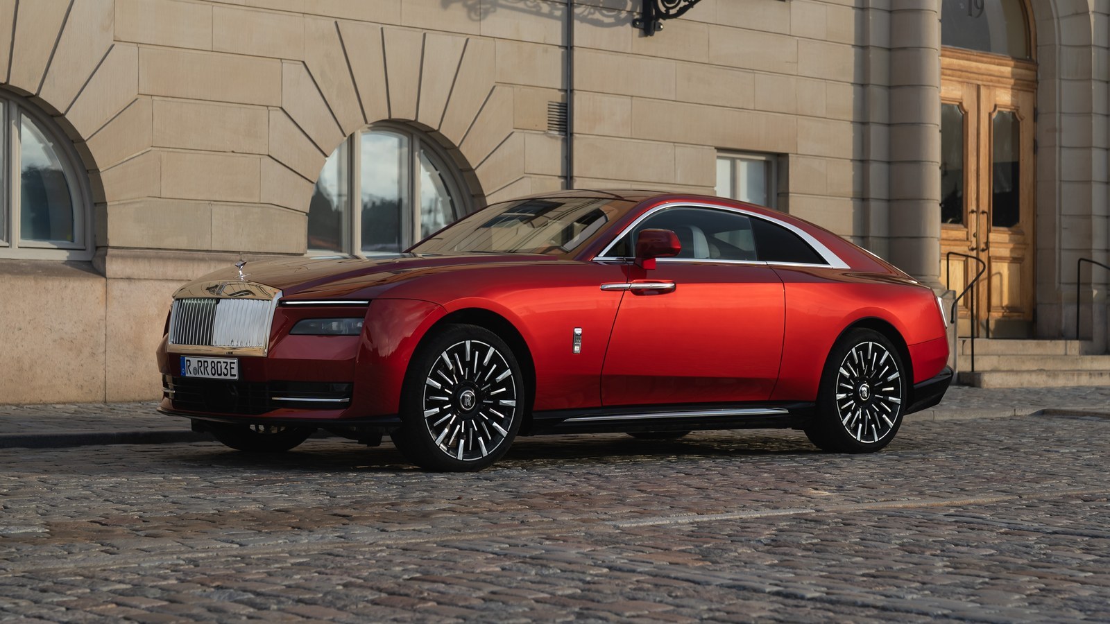 Red Rolls-Royce Spectre Series II parked on cobblestones in Stockholm