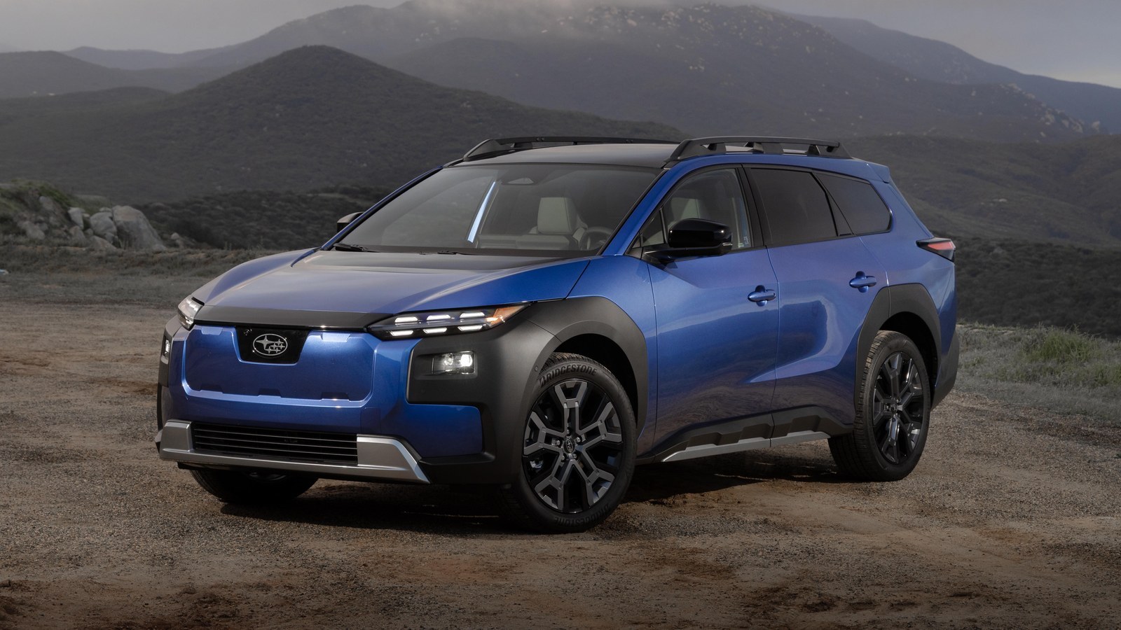 Blue 2026 Subaru Trailseeker electric SUV parked on a mountain road