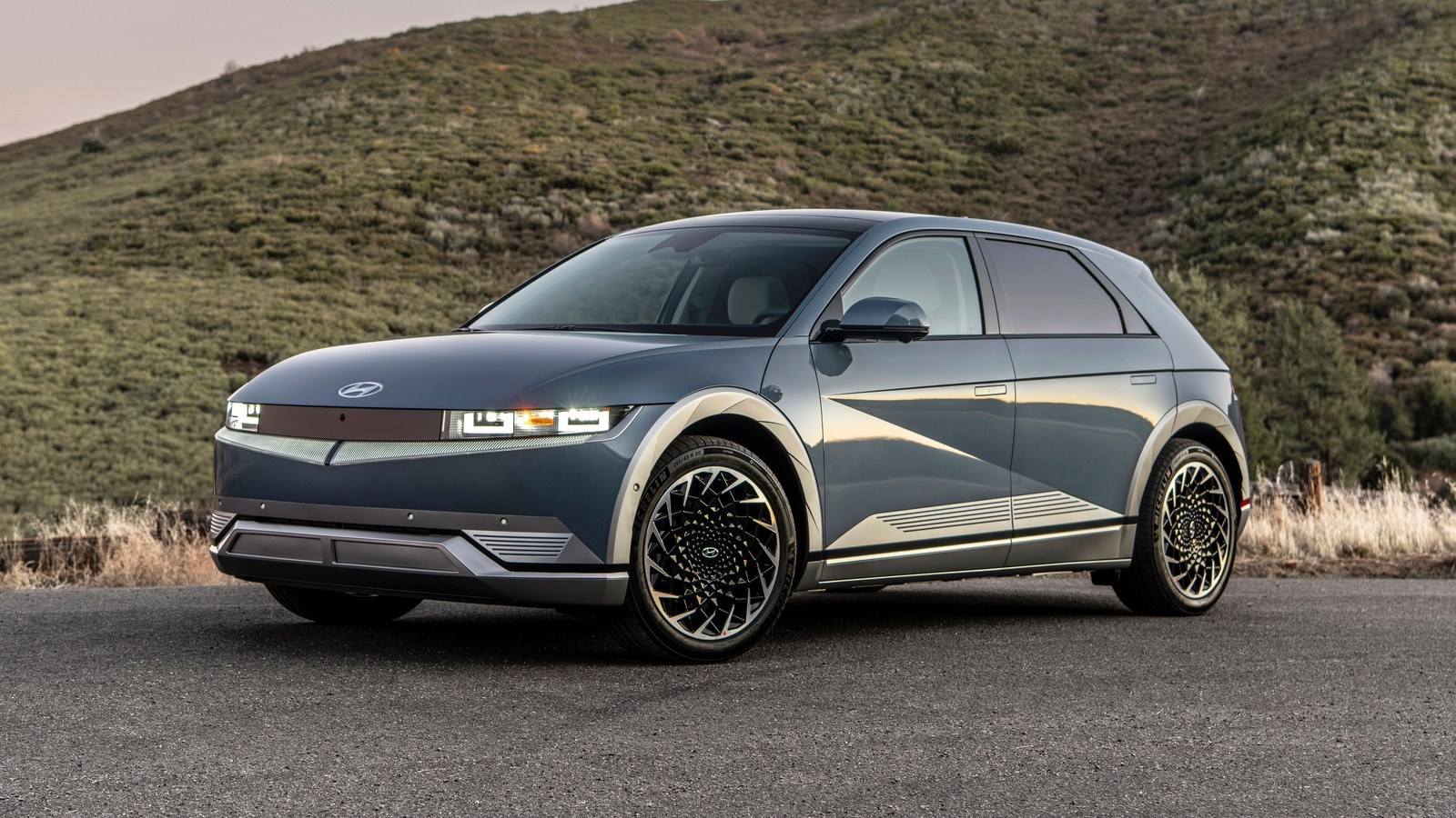 Gray 2023 Hyundai Ioniq 5 parked on a road in hills