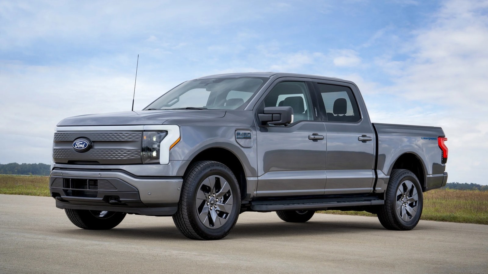 Gray 2024 Ford F-150 Lightning Flash parked on a concrete lot