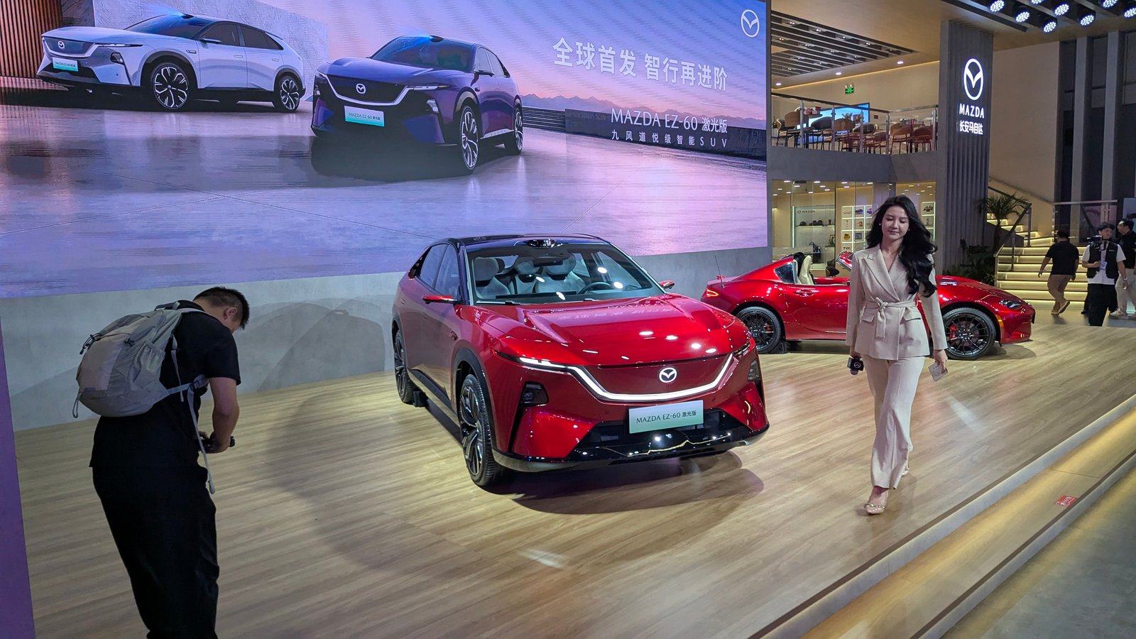 Photographer shooting a Mazda EZ-60 world-premiere display in Chengdu