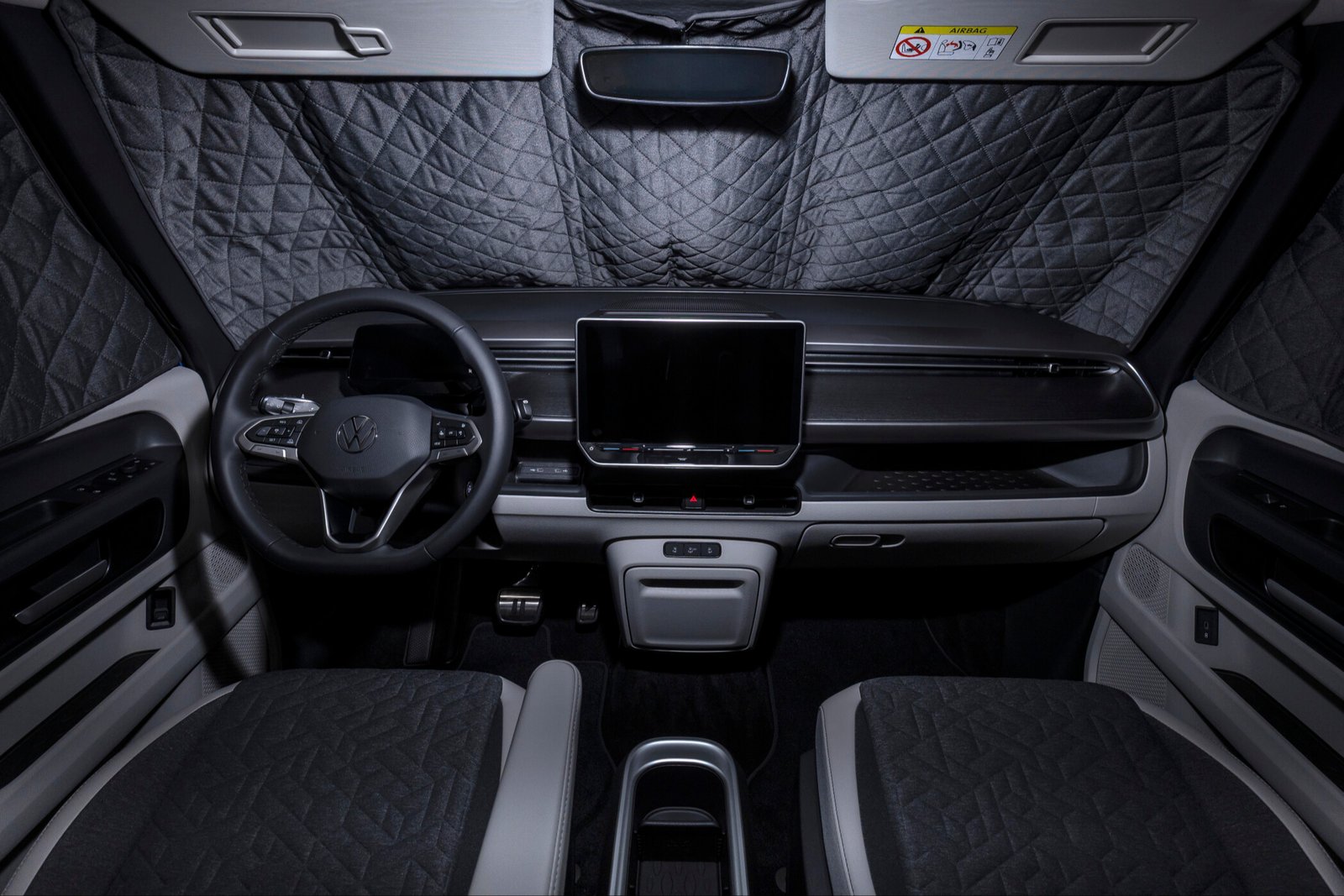 Quilted blackout panels covering the windshield and front windows of the ID. California Cruise