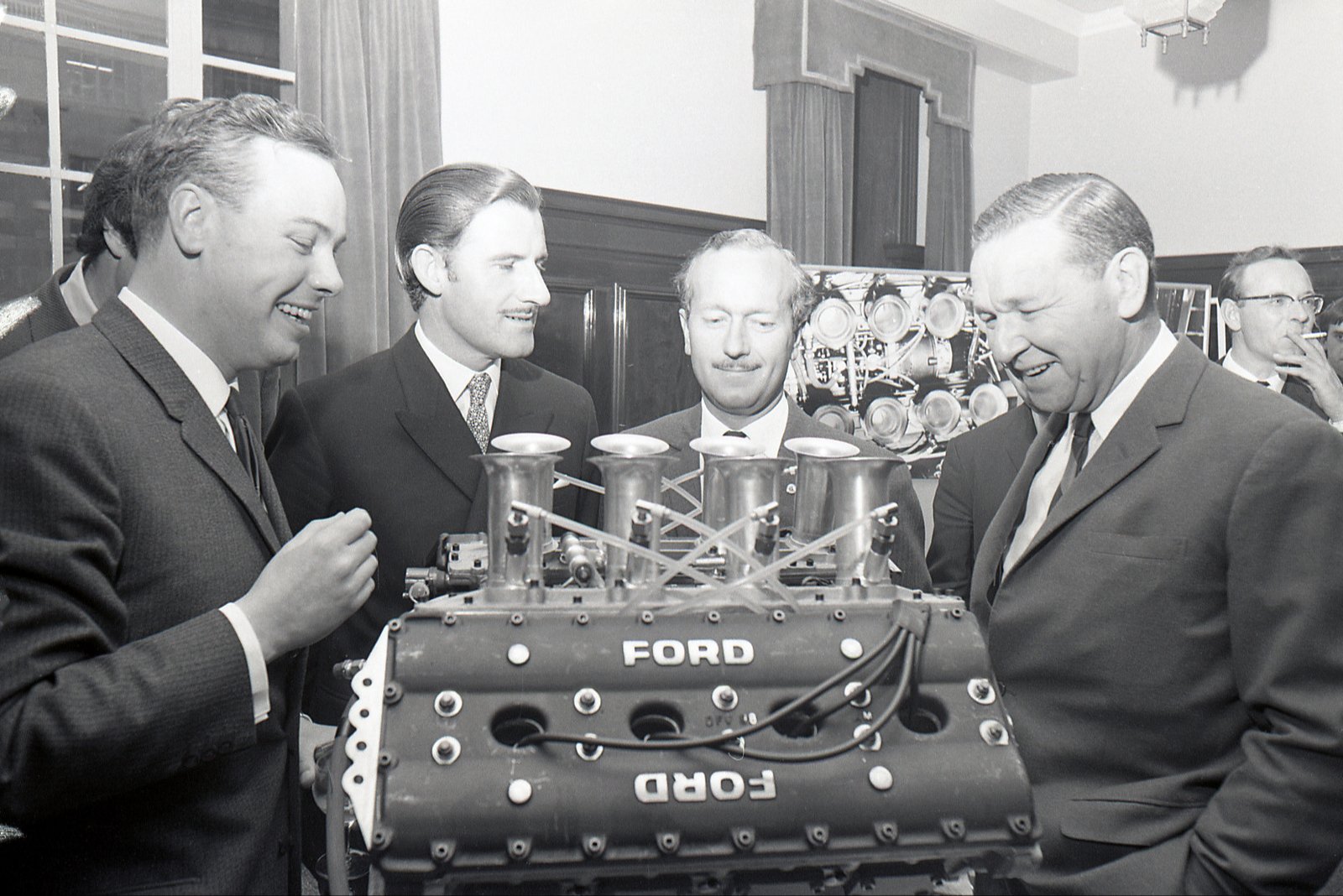 Ford DFV V8 engine displayed at its 1967 press unveiling, surrounded by team figures