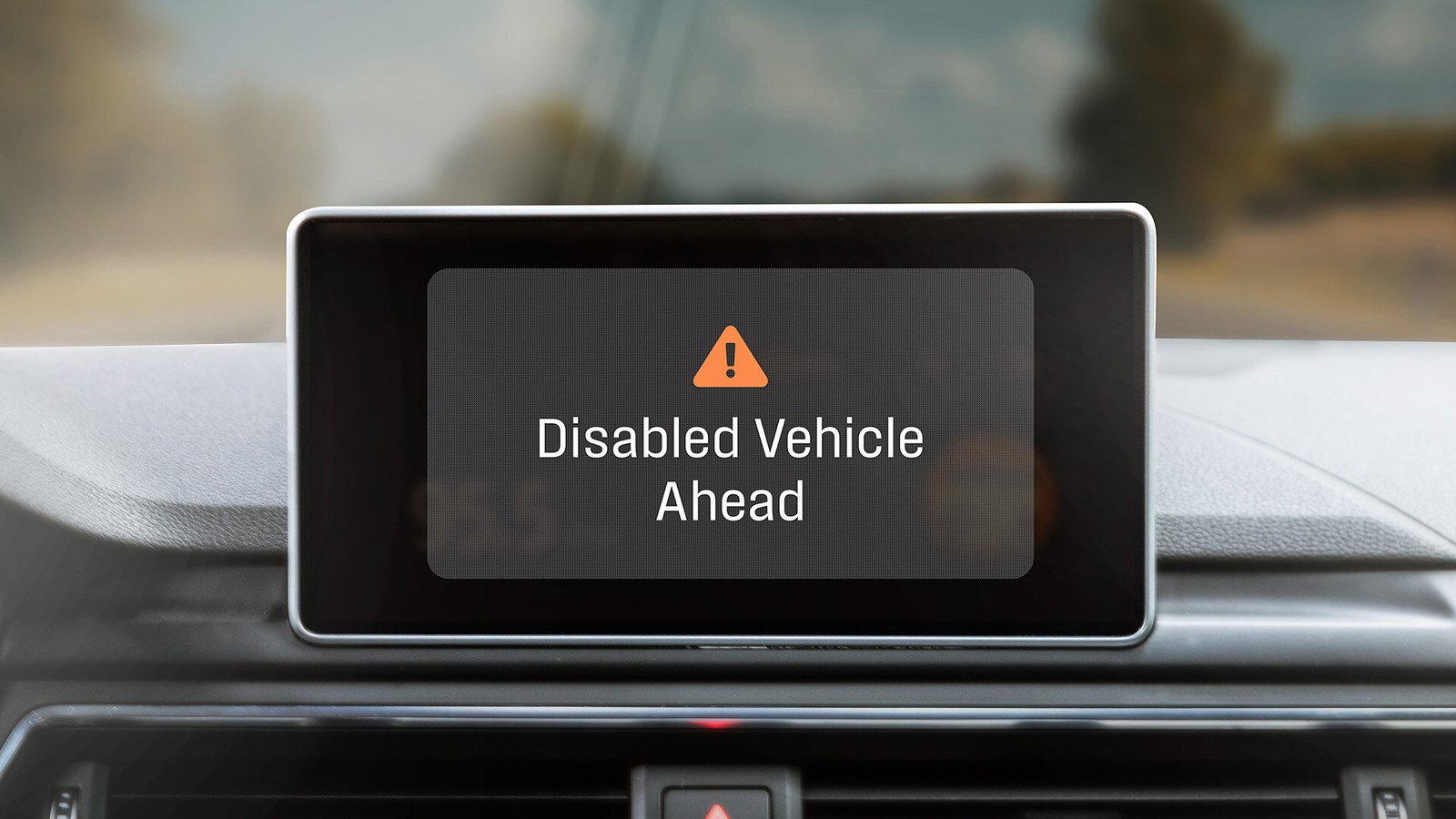 Infotainment screen displaying a Disabled Vehicle Ahead warning from HAAS Alert Safety Cloud