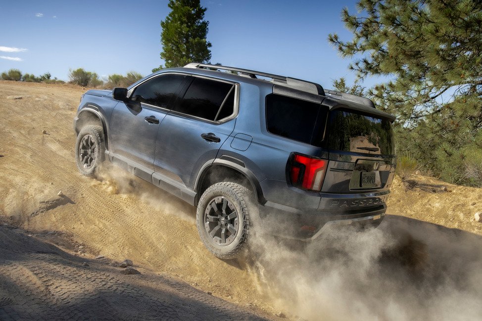 2027 Honda Passport TrailSport cresting a dirt hill off-road