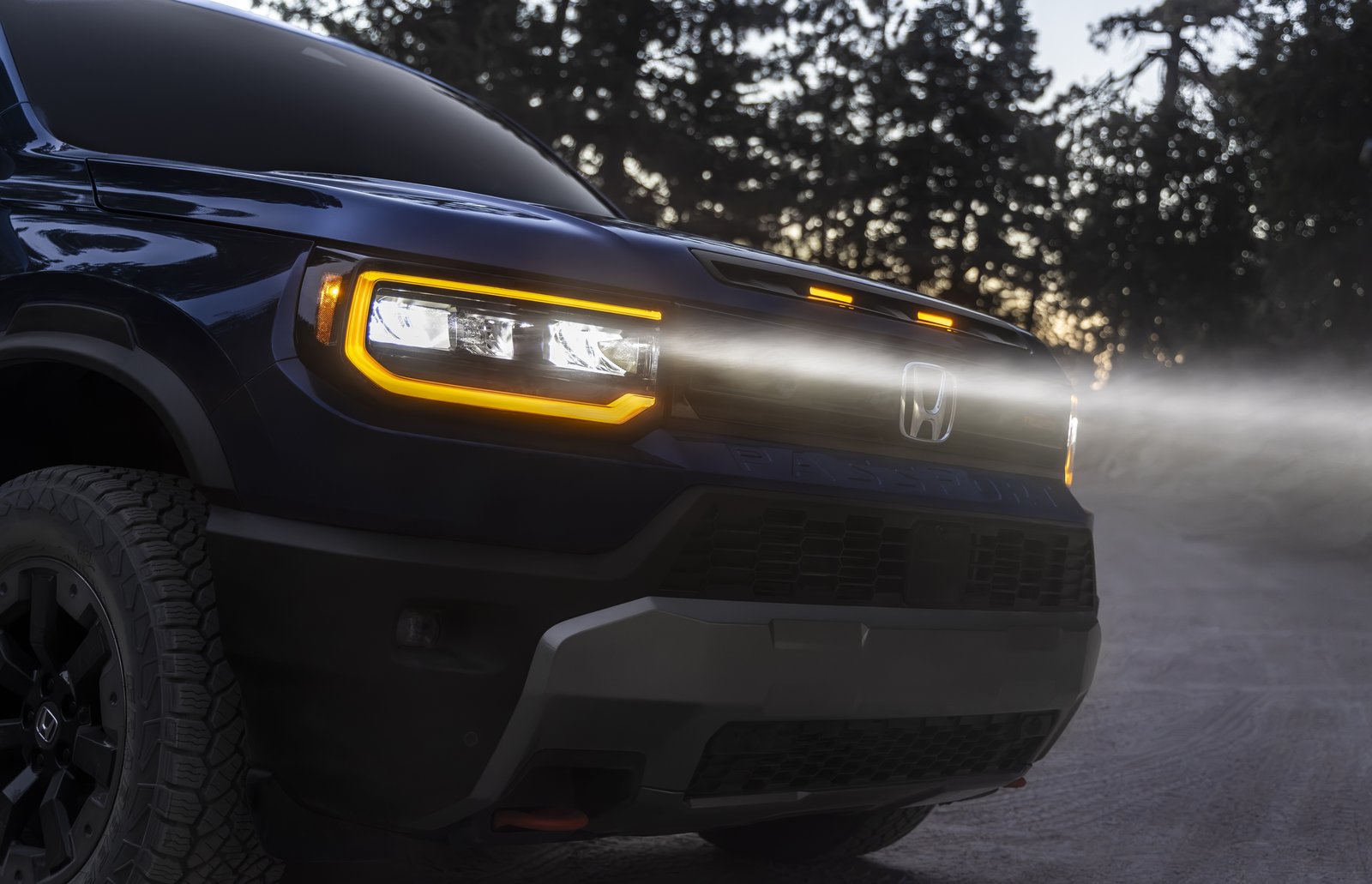 Close-up of Honda Passport TrailSport amber headlight and hood scoop lights