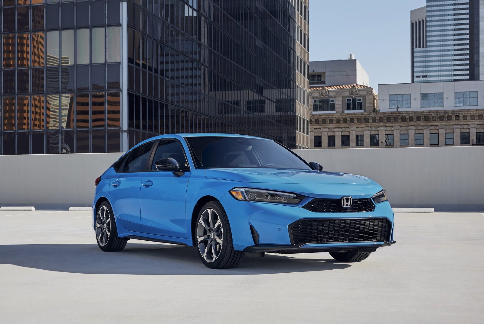 2026 Honda Civic Sport Touring Hybrid hatchback is parked in the city