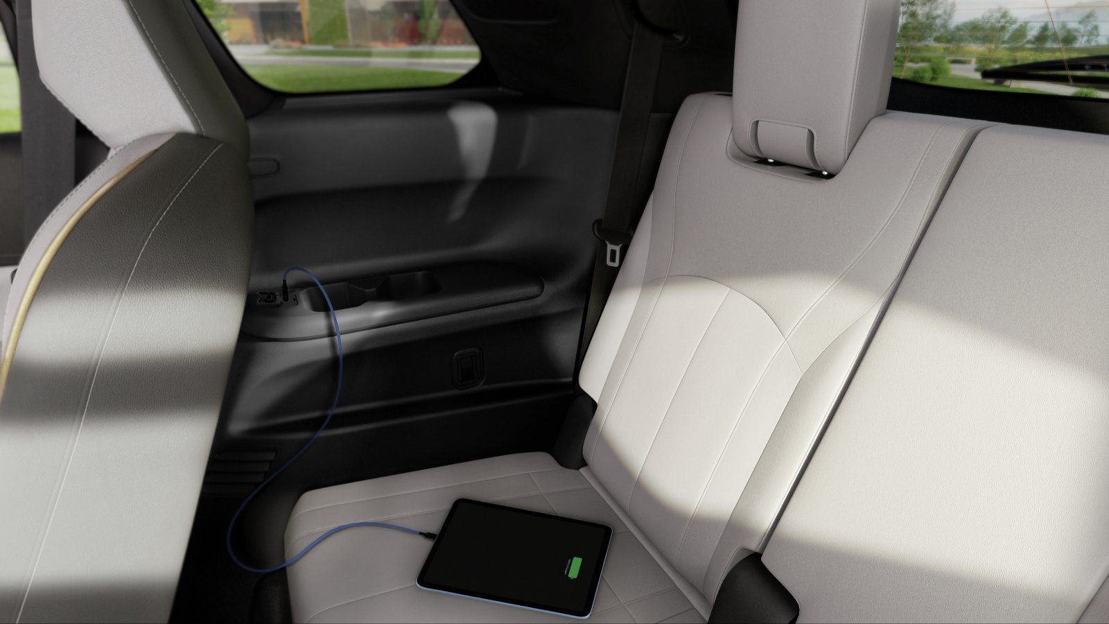 Tablet charging from USB-C port beside Infiniti QX60 third-row cupholder