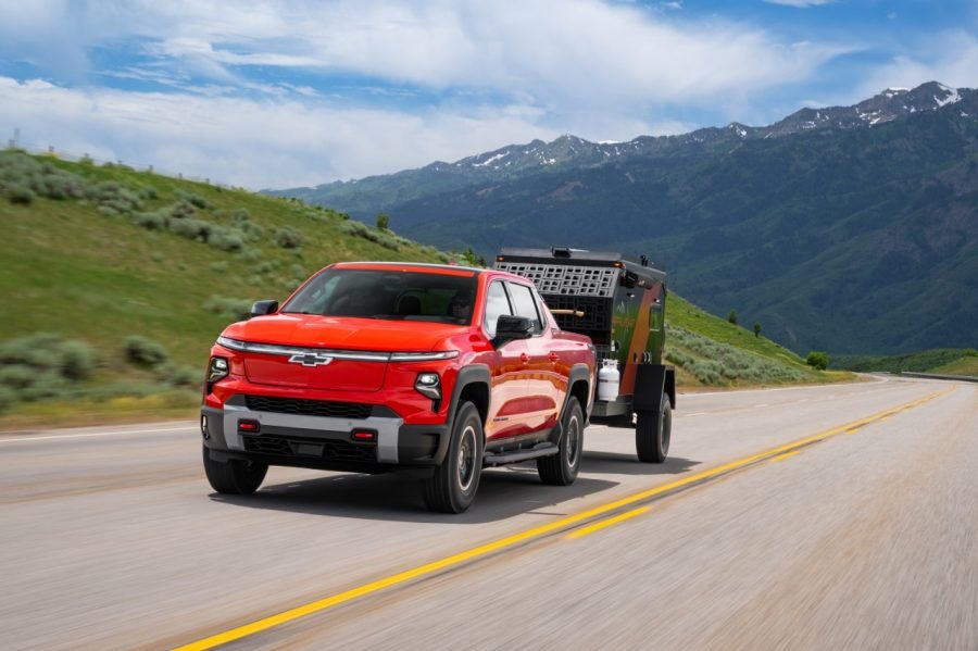 Red 2026 Chevrolet Silverado EV Trail Boss towing a trailer