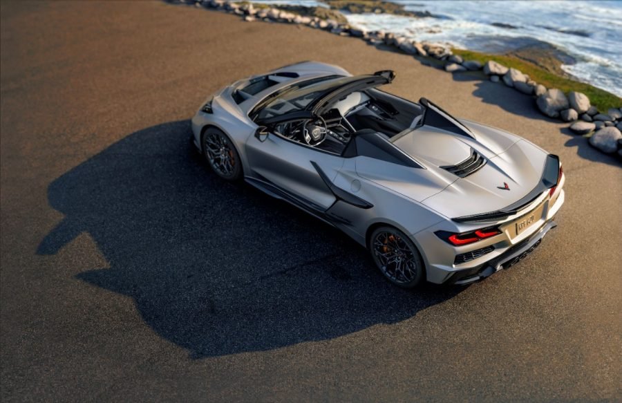 Silver 2026 Corvette ZR1X convertible rear three-quarter view by the ocean