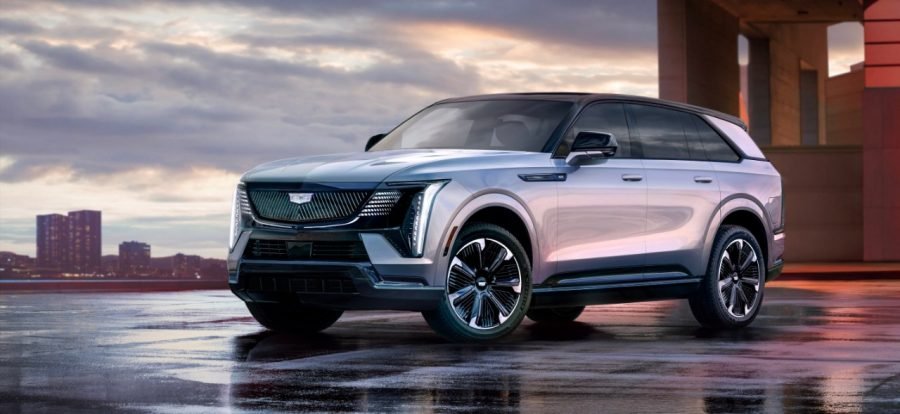2026 Cadillac Escalade IQ Sport electric SUV on a wet waterfront at sunset