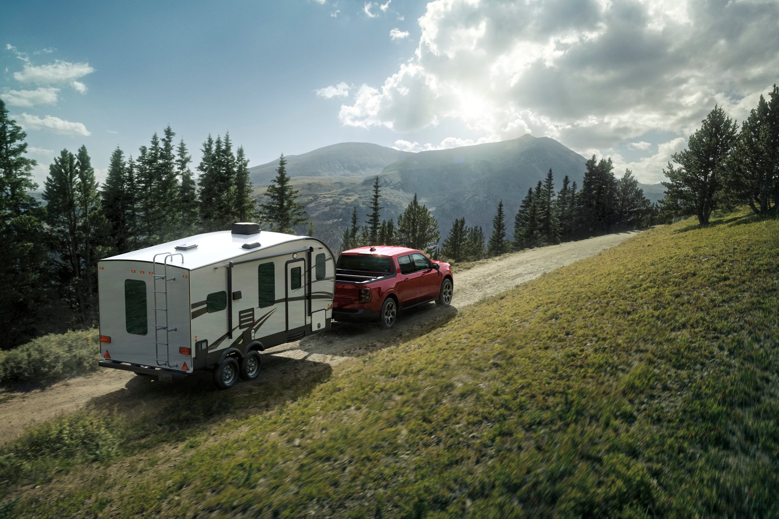 2026 Ford Maverick Lariat towing a travel trailer on a mountain road