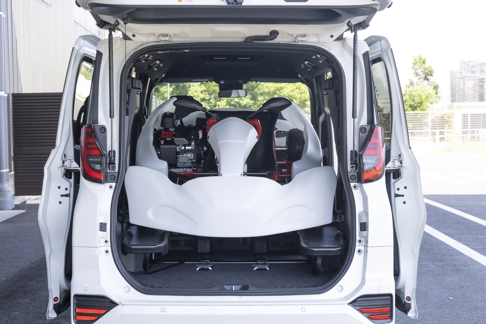 Toyota GR Kart loaded upright inside a Toyota minivan cargo area