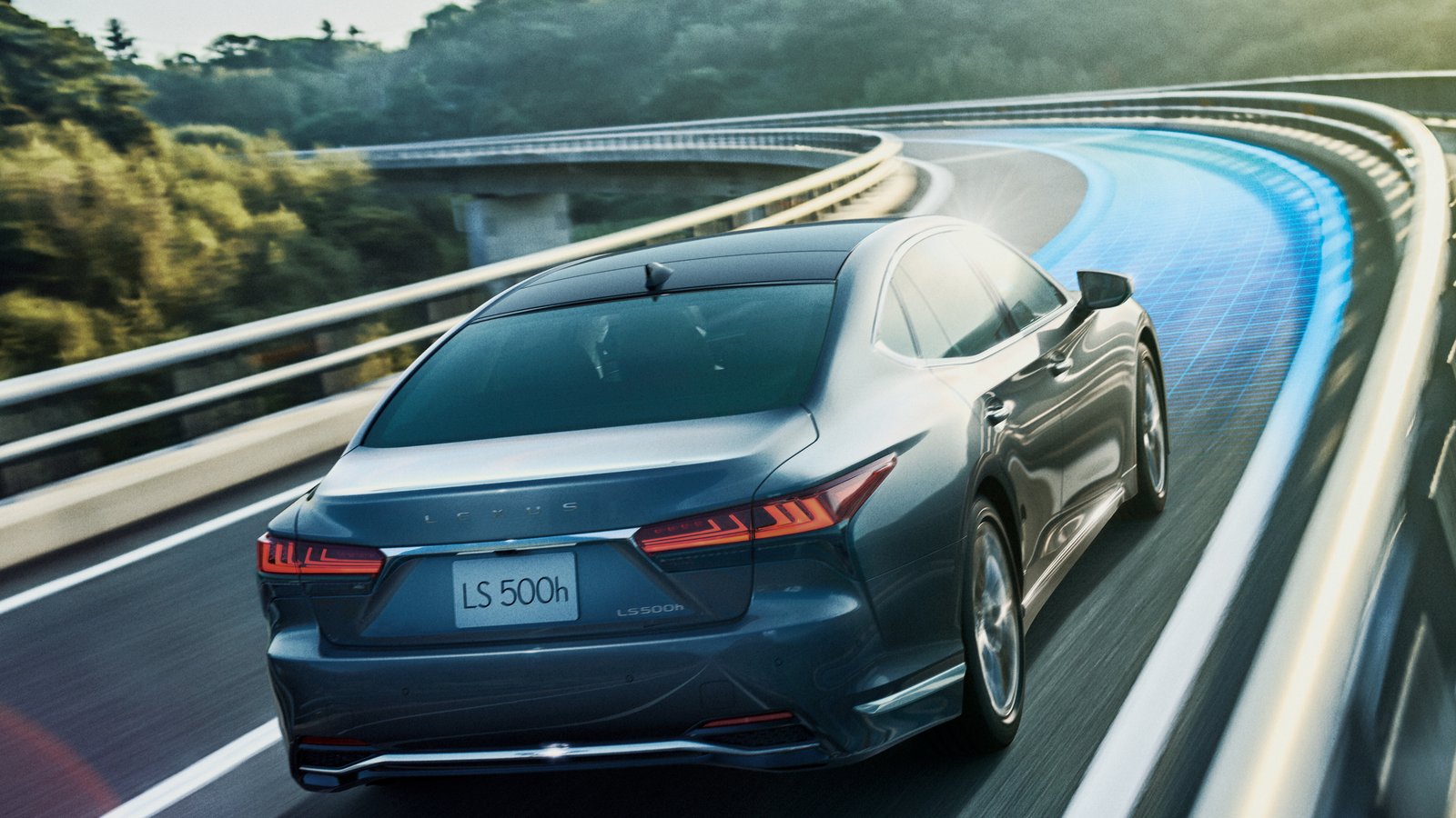 Japan-market Lexus LS 500h driving on an elevated road, rear view