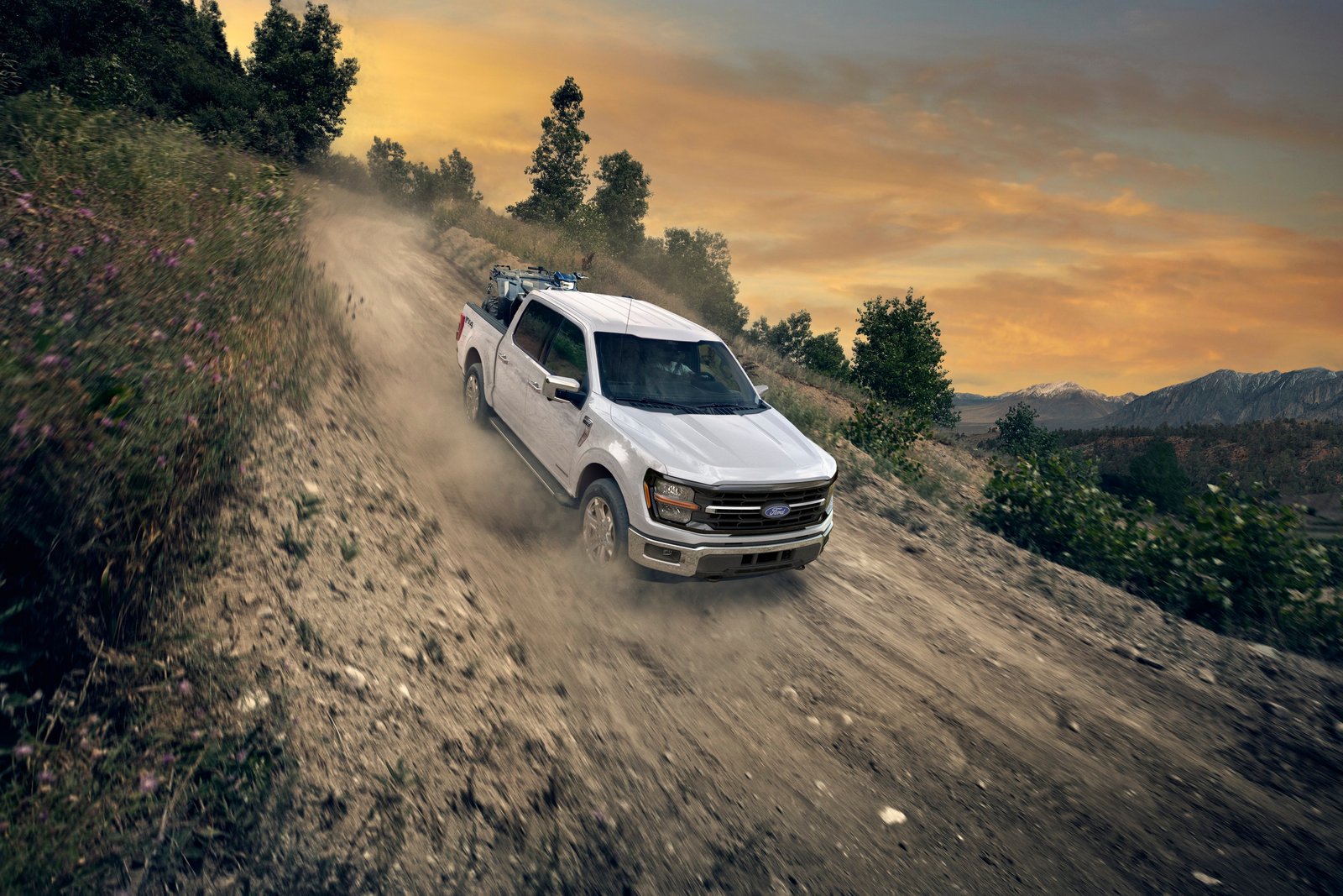 2026 Ford F-150 XLT driving down a dirt trail