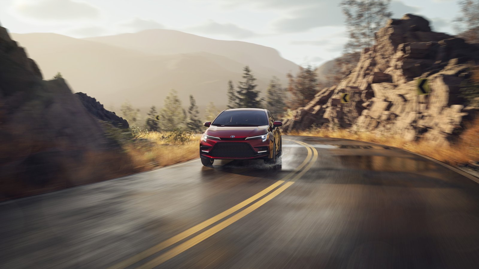 2026 Toyota Corolla Hybrid driving on a mountain road