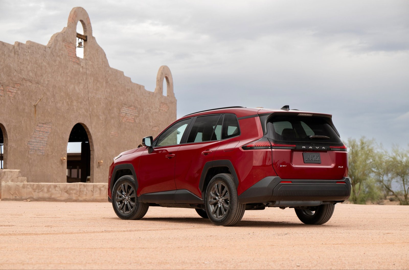 2026 Toyota RAV4 Hybrid in Ruby Flare Pearl, rear three-quarter view