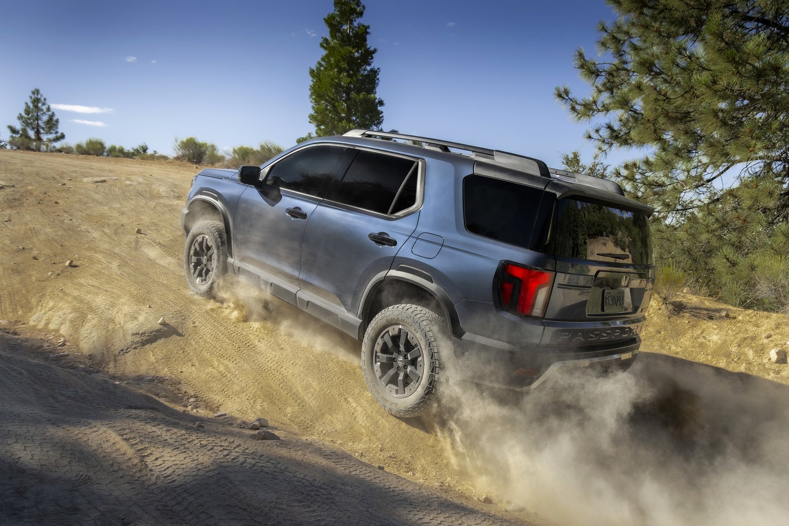 Honda Passport TrailSport climbing a sandy hill, rear three-quarter view