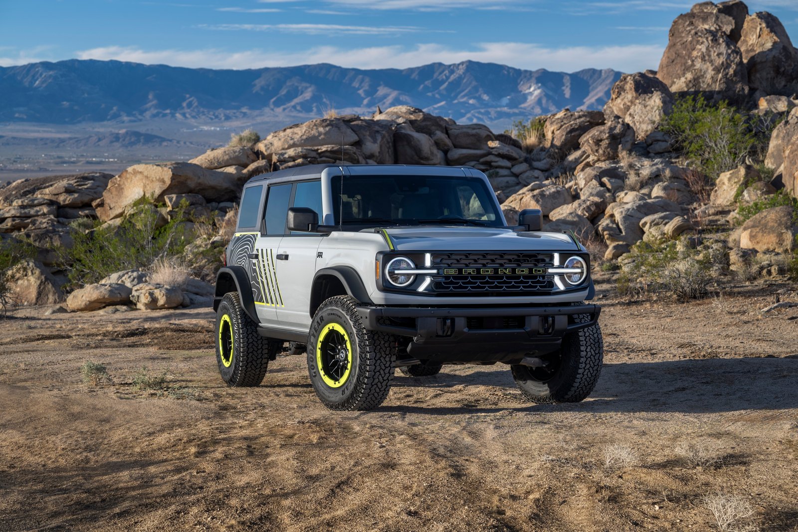 2027 Ford Bronco RTR driving fast through desert sand