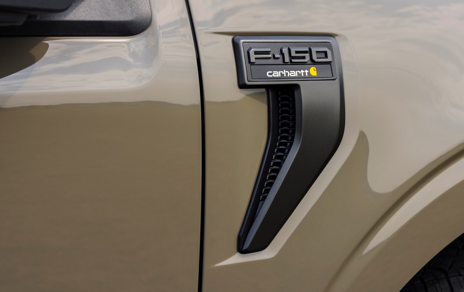 F-150 Carhartt fender vent badge close-up on olive green paint