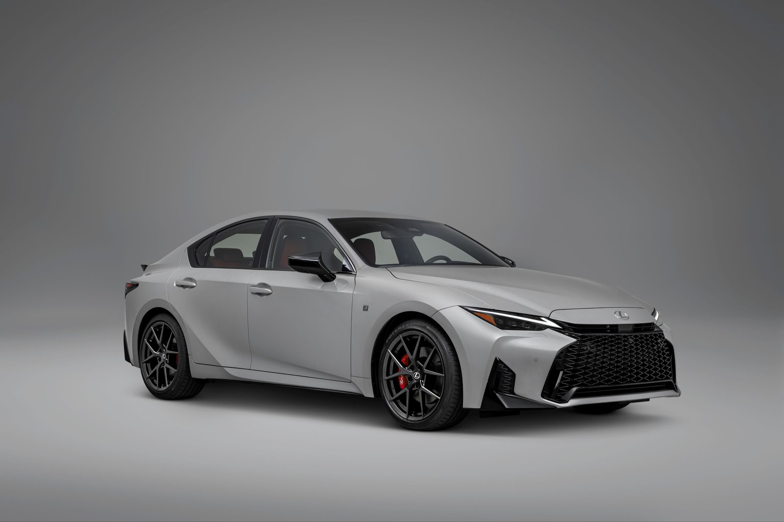 2027 Lexus IS 350 F SPORT front three-quarter view in light gray