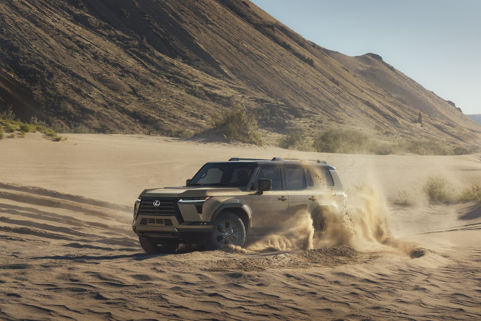 2027 Lexus GX Overtrail driving through sand dunes