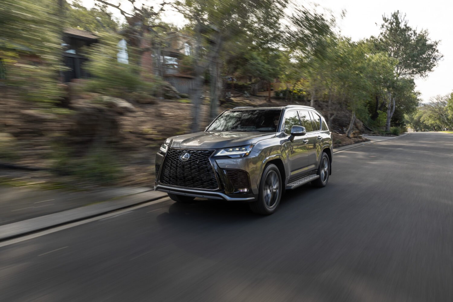 "2027 Lexus LX 700h F Sport Handling in Manganese Luster on the road