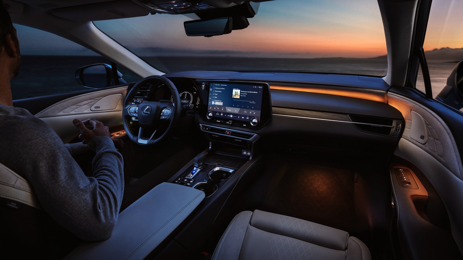 2027 Lexus RX interior at dusk with 14-inch touchscreen and ambient lighting