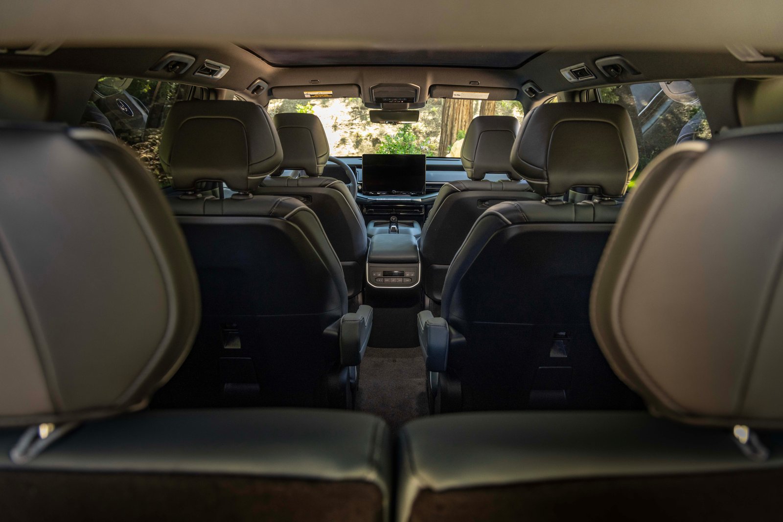 Three rows of seats inside the Subaru Getaway seen from the cargo area