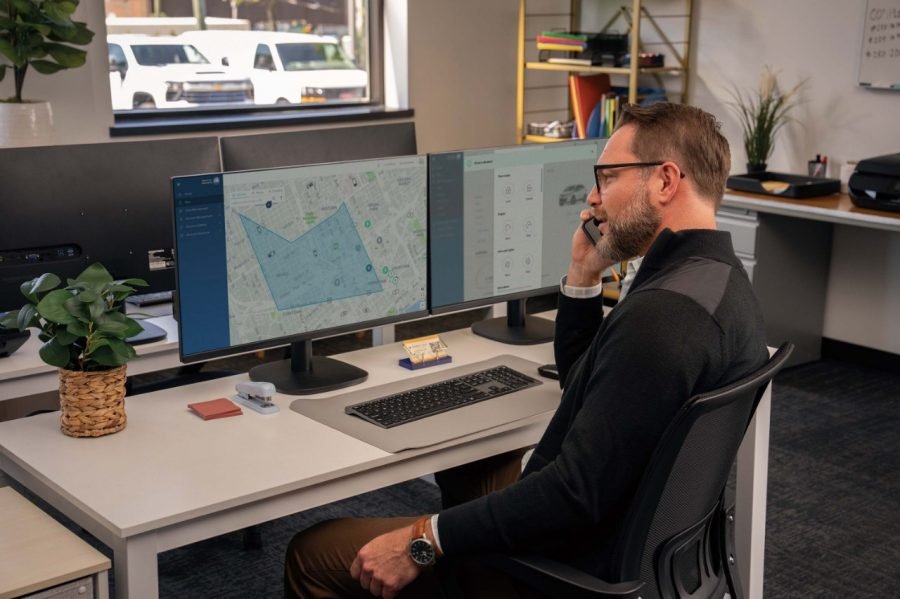 Fleet manager on the phone viewing a geofence map on GM's fleet software
