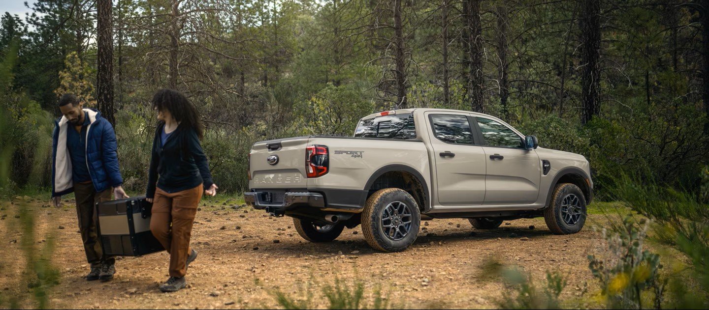 Ford Ranger XLT SuperCrew in Desert Sand parked on a forest trail