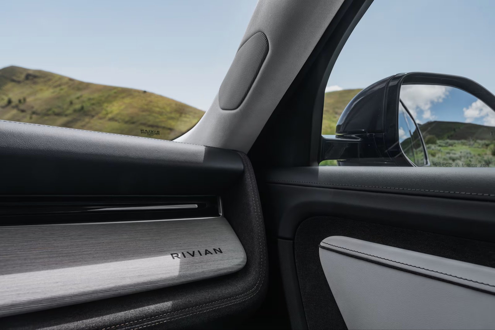 Rivian R2 door panel with birch wood trim in Coastal Cloud Signature