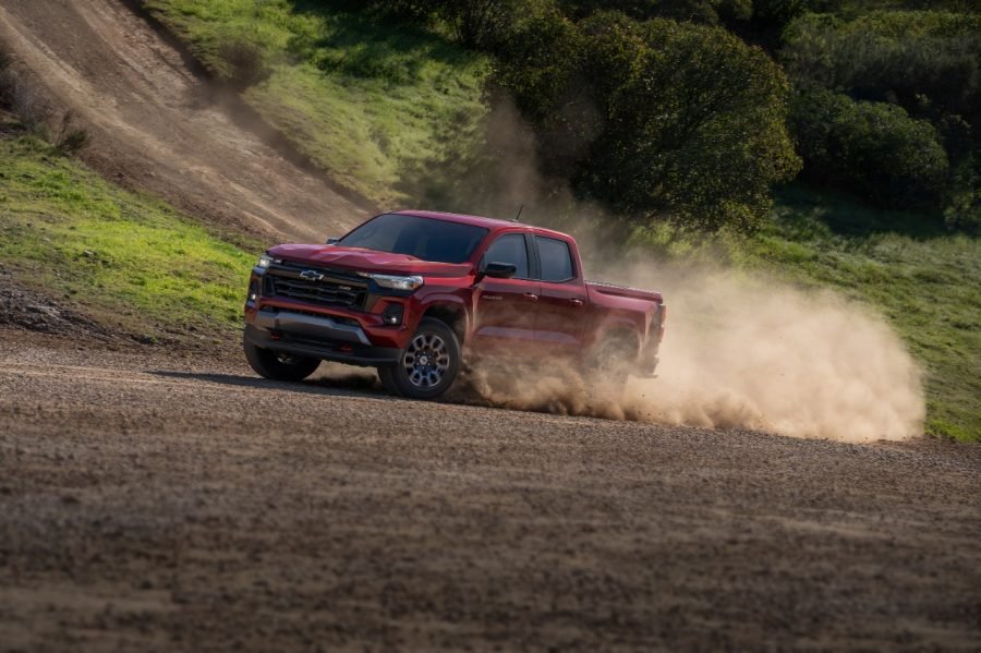 Red 2026 Chevrolet Colorado kicking up dust on a dirt road
