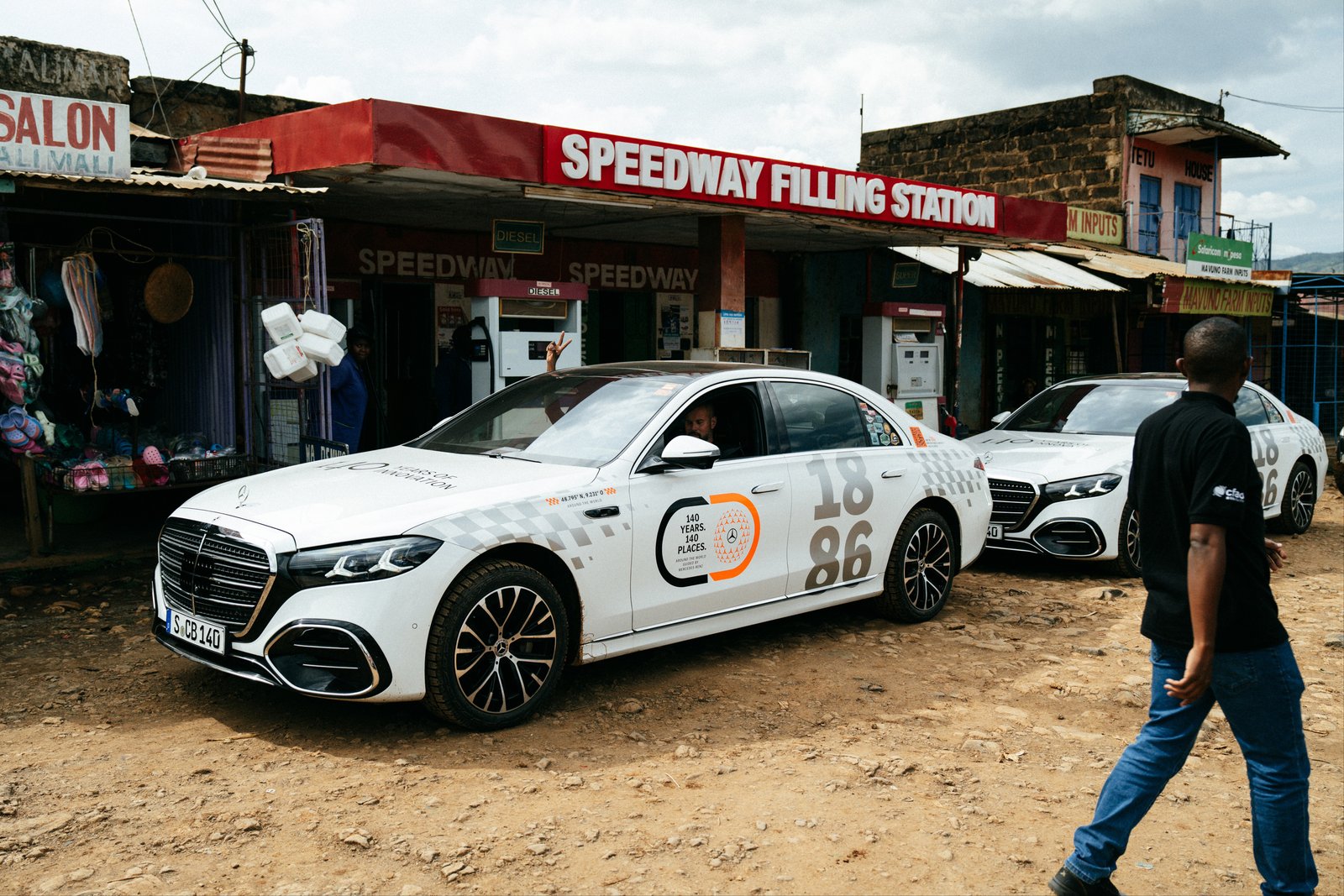 Mercedes S-Class in tour livery at a rural Kenyan filling station