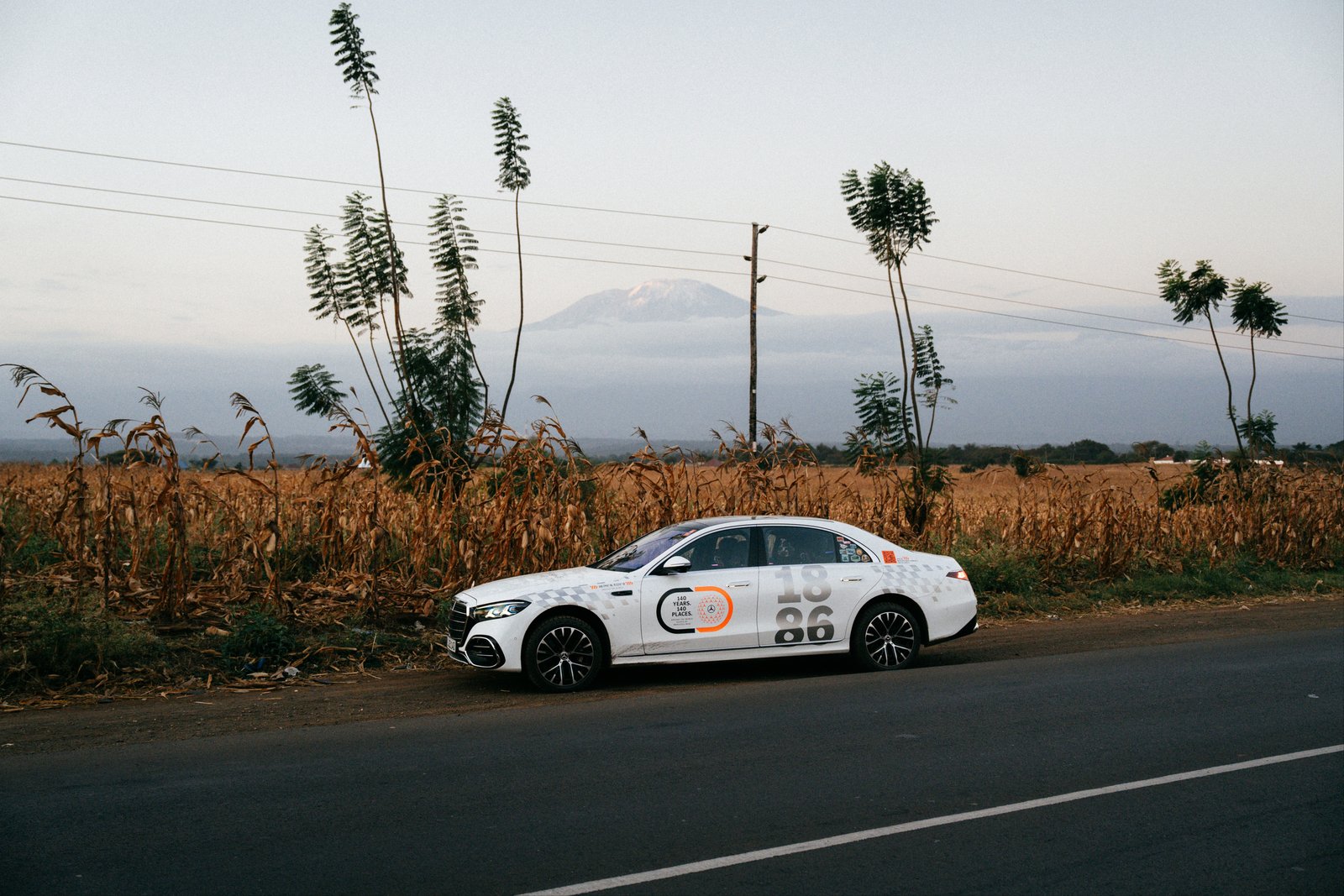 Mercedes S-Class parked roadside with Kilimanjaro faint in the distance