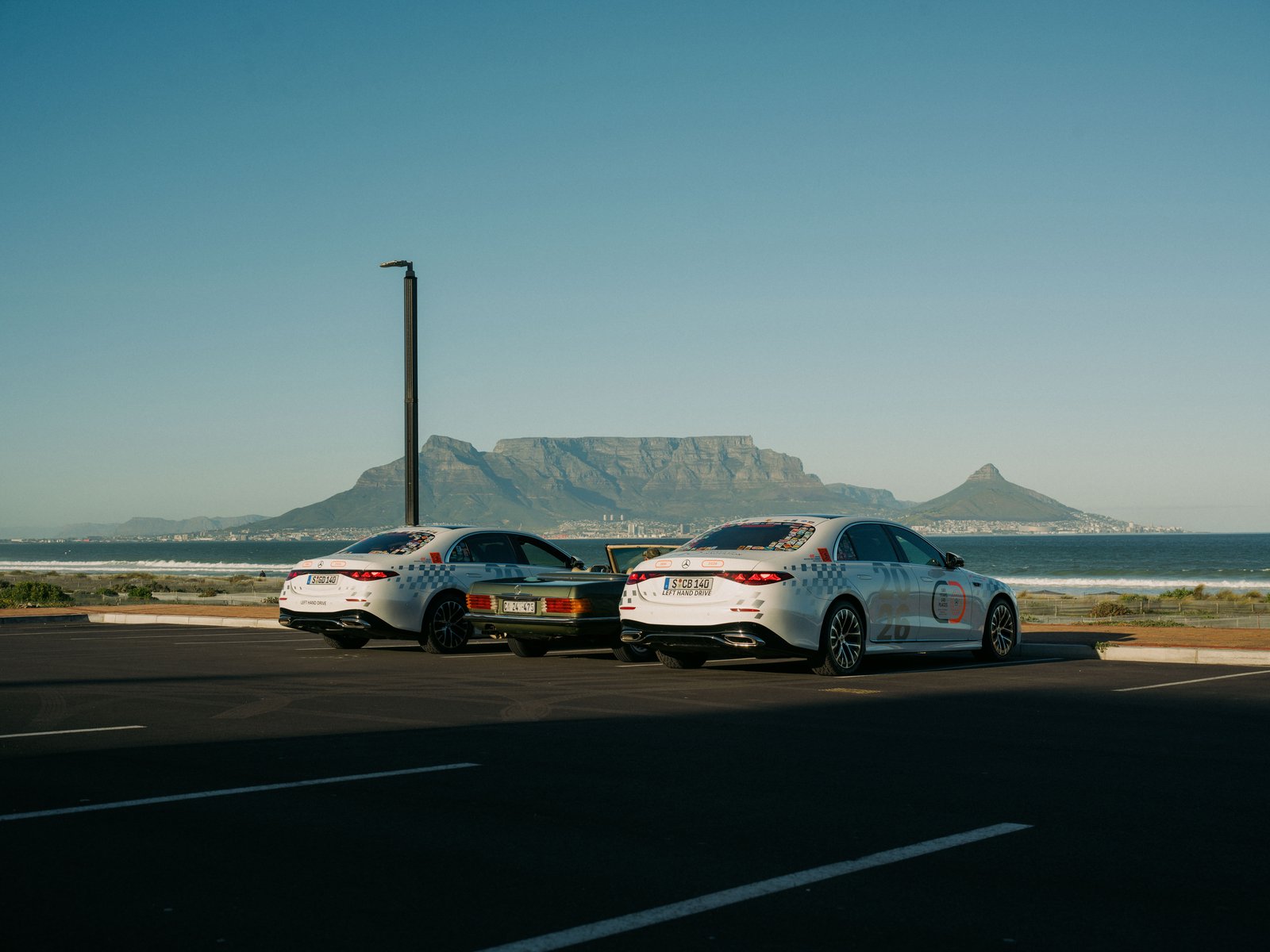 Two Mercedes S-Class sedans parked with Table Mountain in the background
